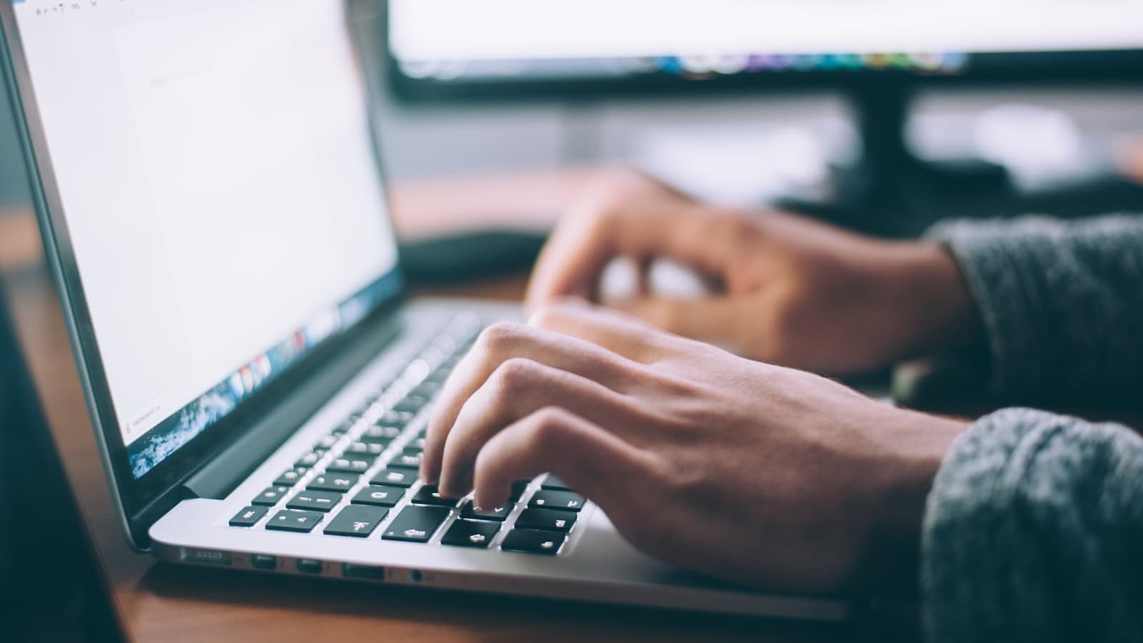 Best AI tools for writers — a person typing on a MacBook