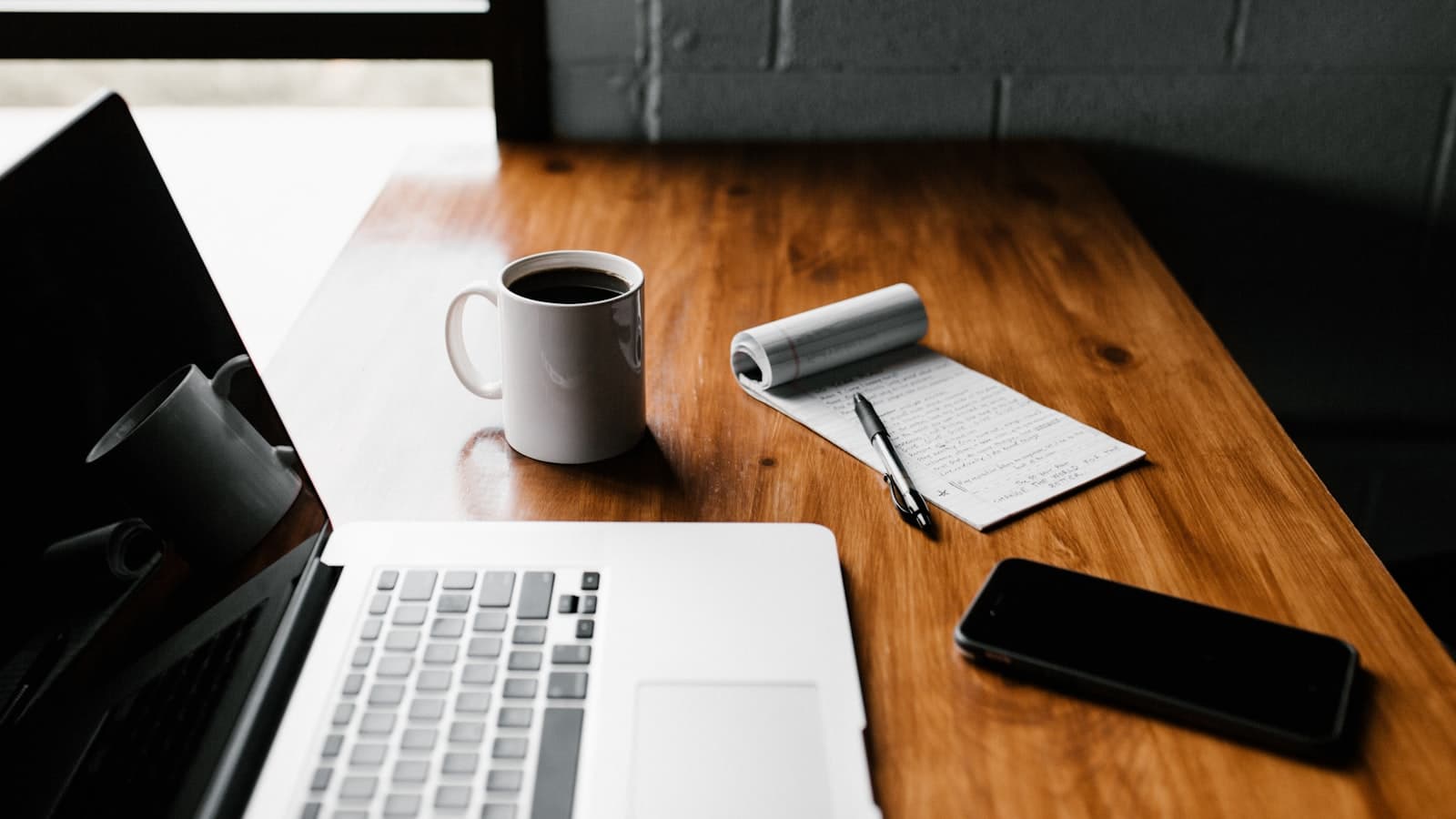 Deep work in an age of distraction — a focused desk with a laptop and coffee