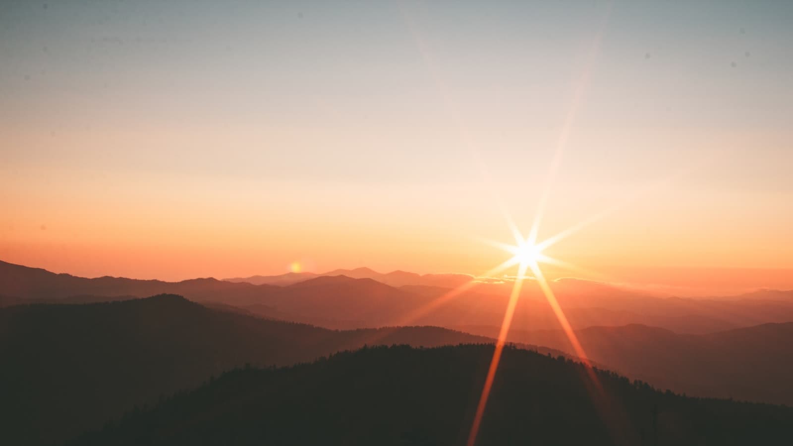 AI and the soul — mountains silhouetted against a sunset