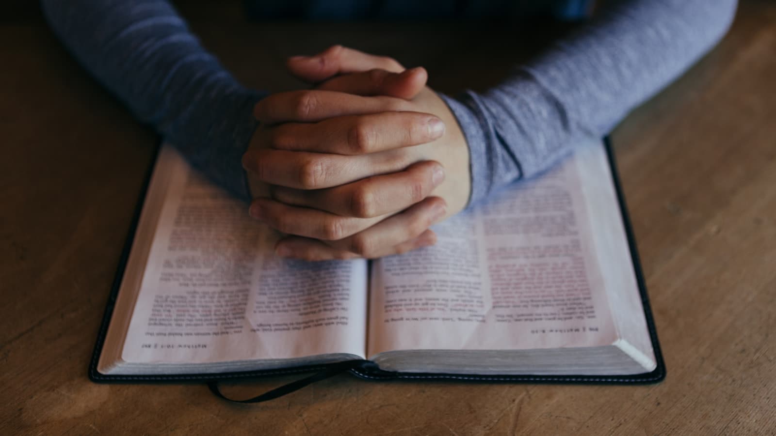 Holy Spirit vs ChatGPT — hands resting on an open Bible