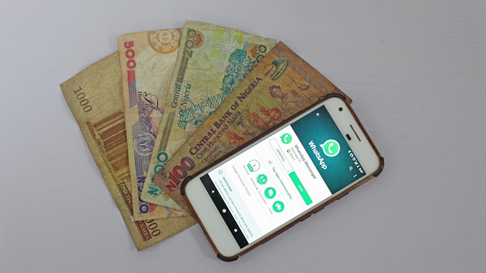 Keep mobile money safe — a smartphone beside banknotes