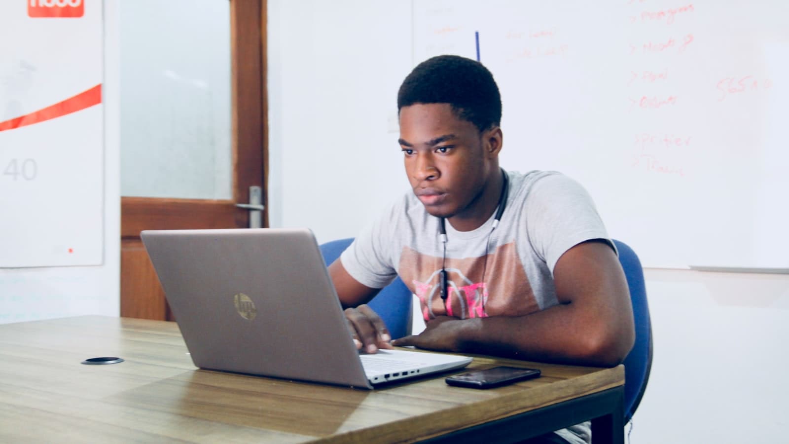 Learning AI in Tanzania — a young African man using a laptop