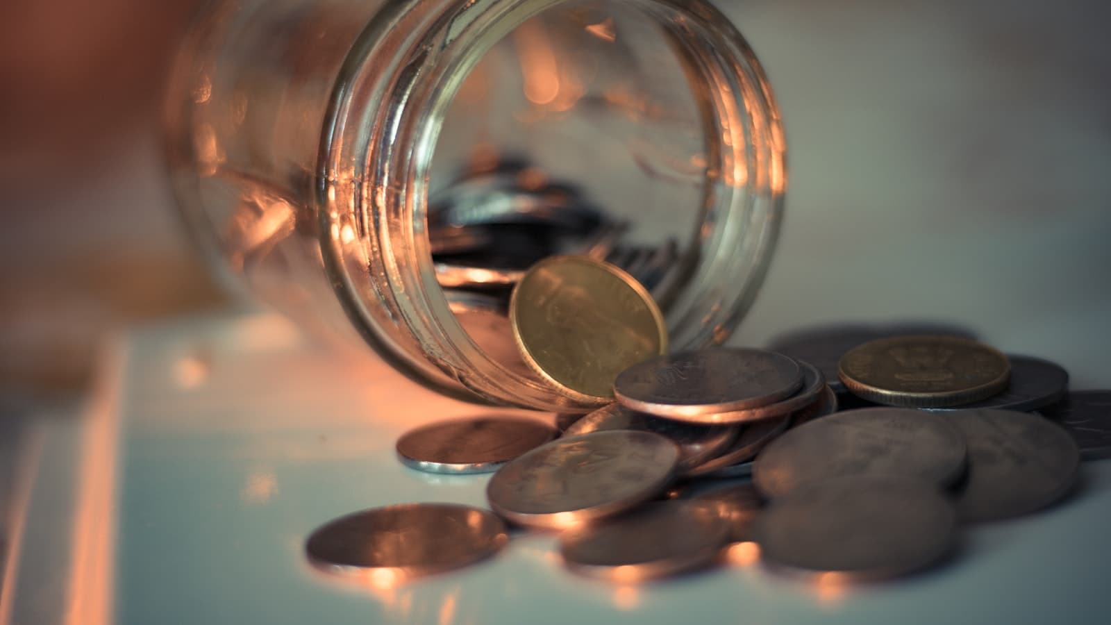 Money mental models — coins saved in a glass jar