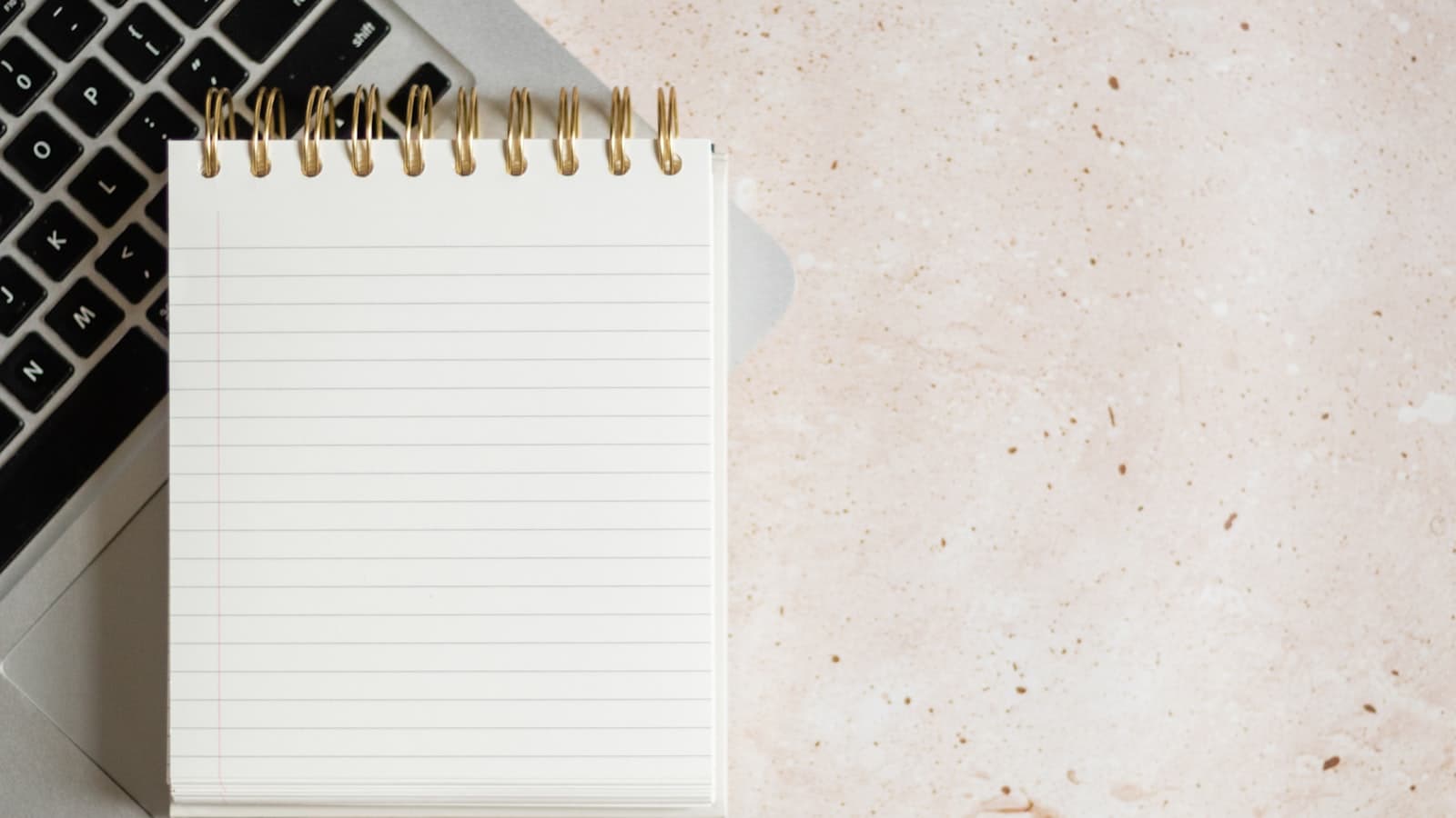 Notion vs Obsidian — a notebook and a laptop on a desk