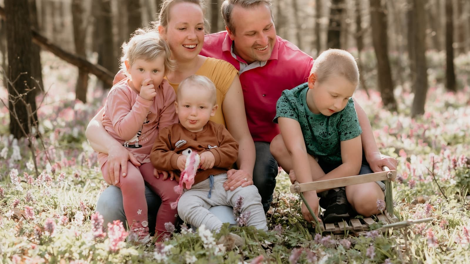 Raising kids with faith — a family sitting together outdoors